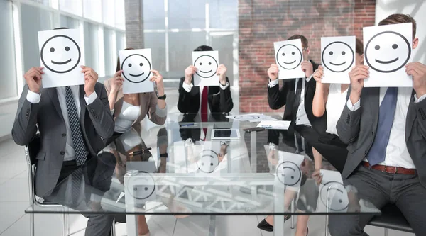 Business Team holding a paper with a positive smiley Stock Photo