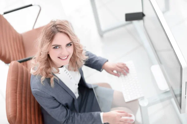 smiling business woman sitting behind a Desk