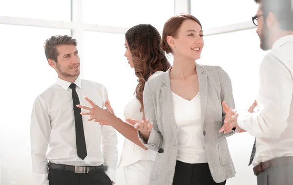 Young employees talk in the office — Stock Photo, Image