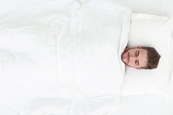 View from the top.smiling man lying on a comfortable mattress — Stock Photo, Image