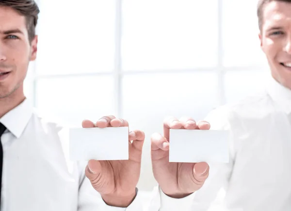 Close up. Two businessmen showing their business cards — стоковое фото