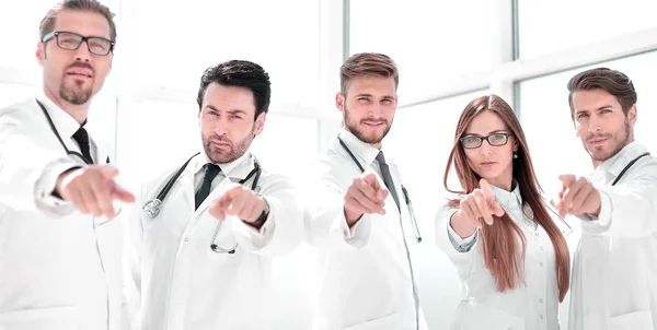 group of practicing doctors pointing their finger at you