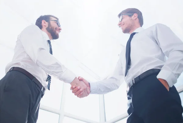 Bottom view.handshake business people standing in the office — Stock Photo, Image