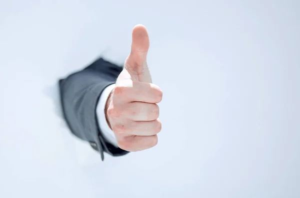 Businessman breaks through the paper and shows his thumb up — Stock Photo, Image