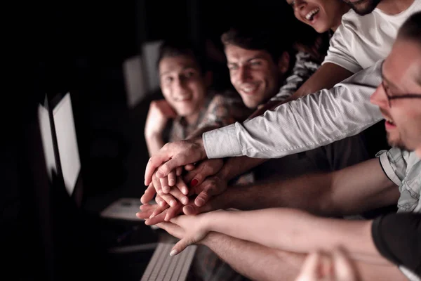 Close up. Young active office workers hold their hands together — стоковое фото