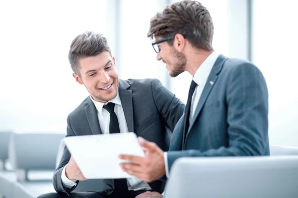 Image of two young businessmen using touchpad at meeting — Stock Photo, Image