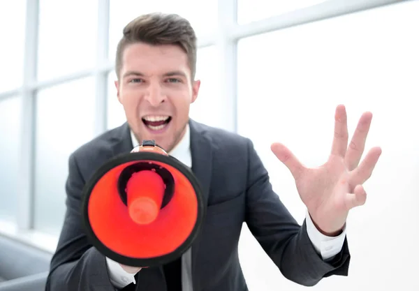 Businessman screaming into a megaphone — Stock Photo, Image