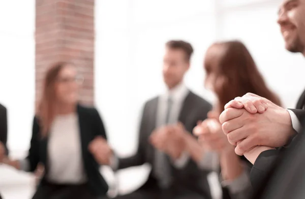 Business group in a circle holding hands indoors — Stock Photo, Image