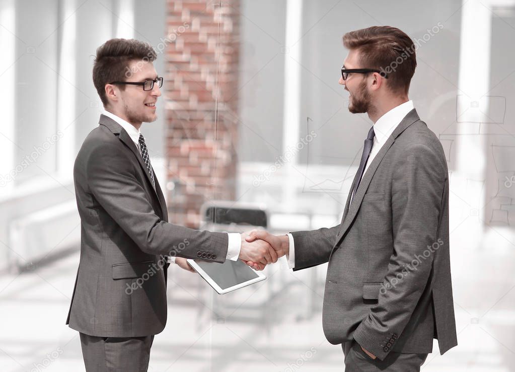 colleagues greet each other with a handshake