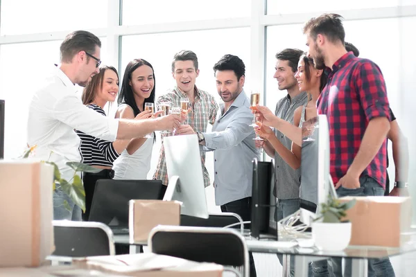 Бізнес-команда виховує келихи для вина, стоячи в офісі — стокове фото