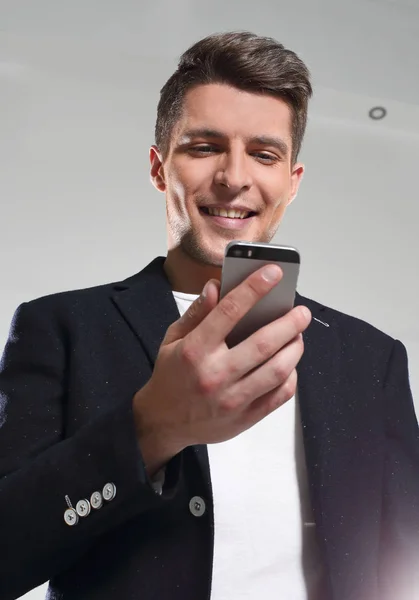 Ung kille i en jacka som pratar i telefon — Stockfoto