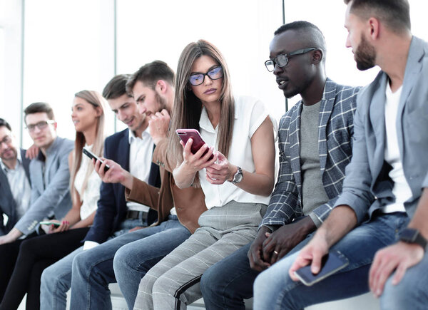 group of young people using modern gadgets