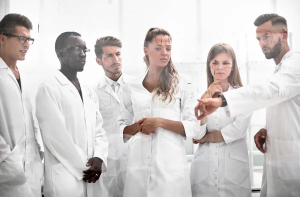 Thoughtful scientists look at formulas — Stock Photo, Image
