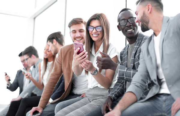 group of young people with smartphones