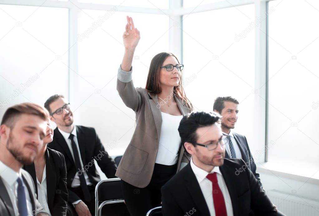 business woman asks a question at a business meeting