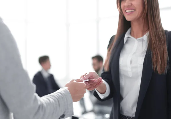 close up.business woman giving business card to a business partner