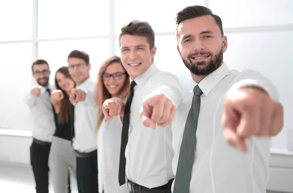 Business team standing in new office and pointing forward — Stock Photo, Image