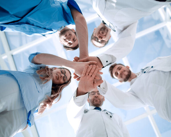 Portrait of a doctor team connecting hands stacking