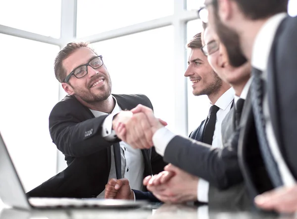 Business partners reaching out to each other for a handshake — Stock Photo, Image
