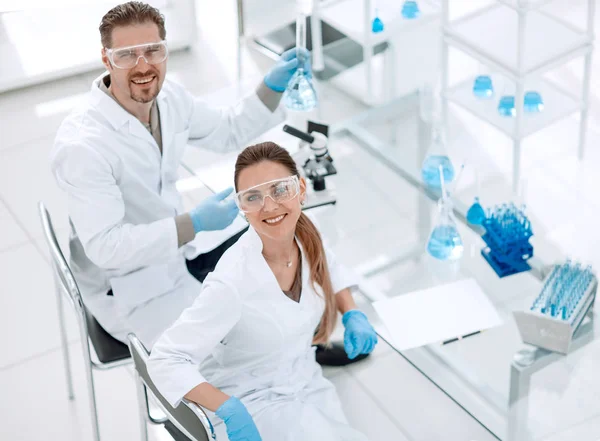two positive scientists are working in the laboratory.