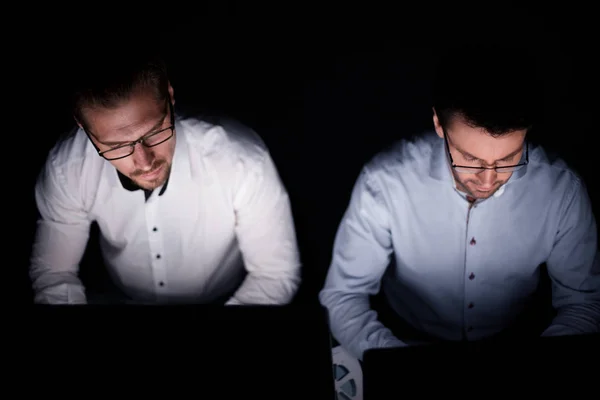 Close up .two colleagues working on computers — стоковое фото