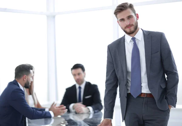 Young businessman standing near the office Desk — Stock Photo, Image