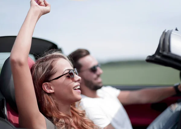 Close up.una joven con su novio en un coche descapotable — Foto de Stock