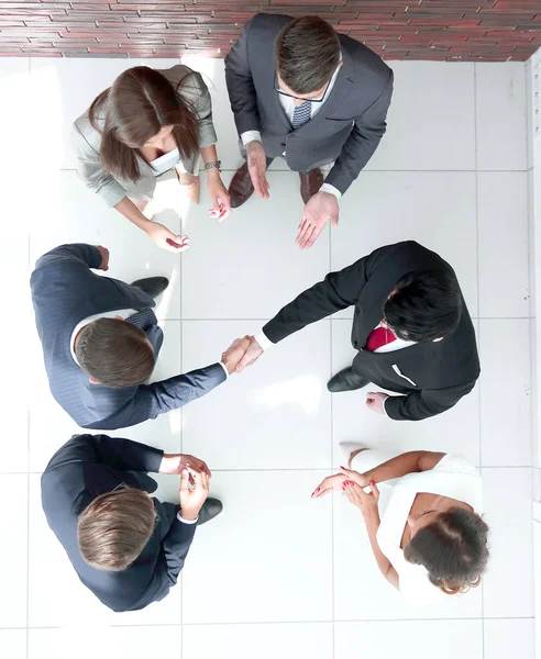 Top view.business partners shaking hands — Stock Photo, Image