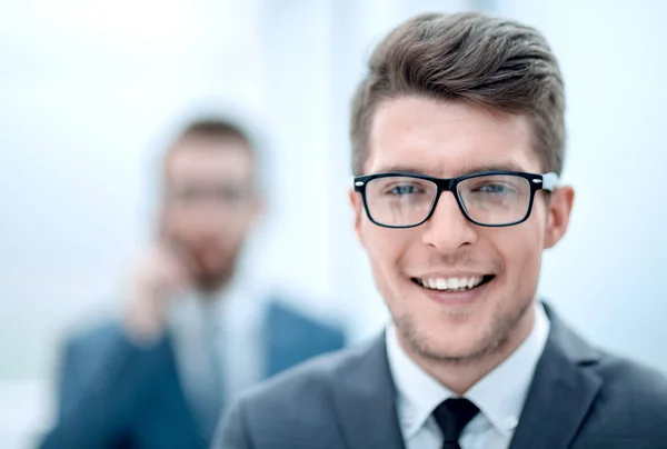 Zamknij up.smiling młody biznesmen w tle office — Zdjęcie stockowe