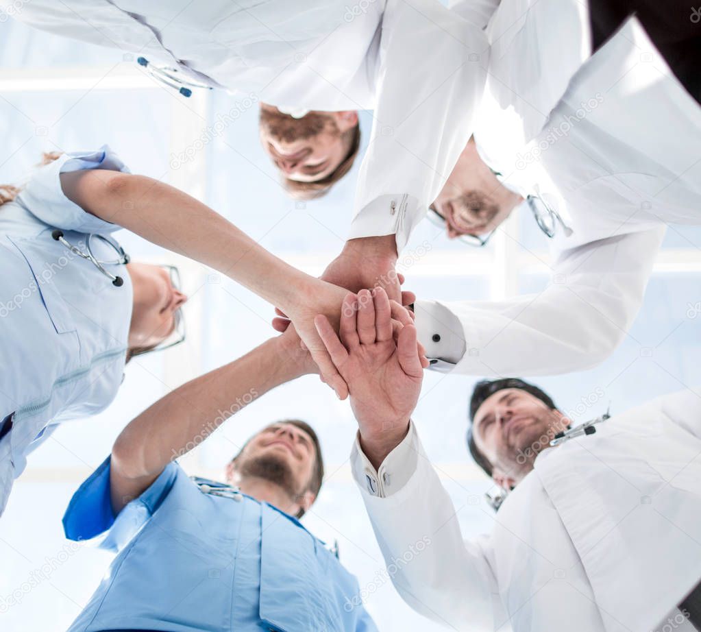 Health care workers demonstrating unity, bottom view