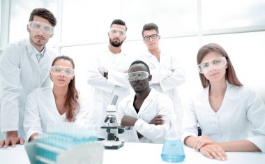 Grup genç başarılı bilim adamı kamera için poz