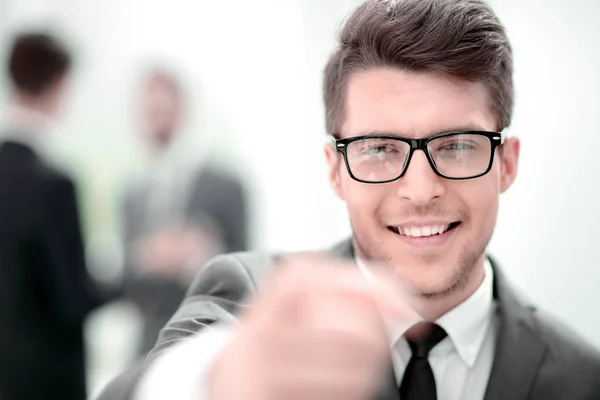 Close up.careful young business man in blurred background. — Stock Photo, Image