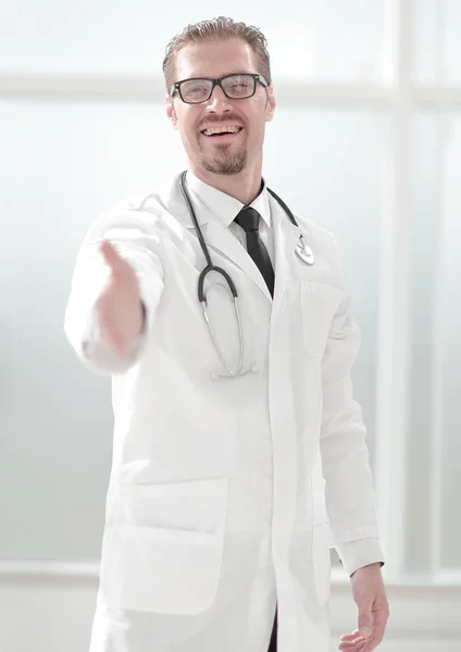 friendly doctor extending his hand for greeting