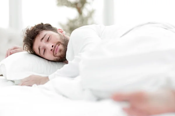 Closeup.the tired men sleep soundly on the bed — Stock Photo, Image