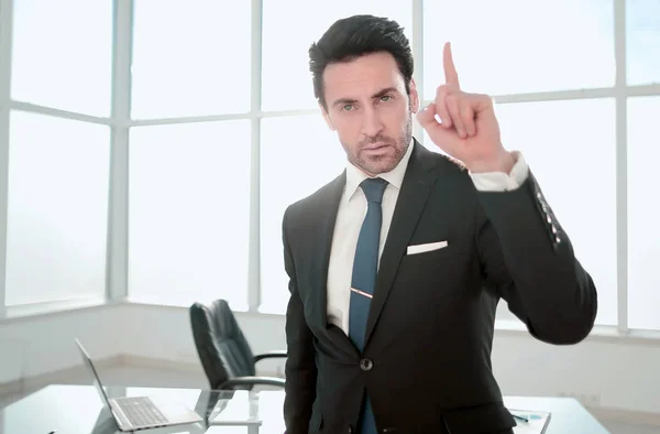 Responsible businessman standing near his Desk. — Stock Photo, Image