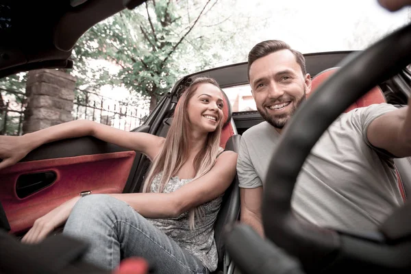 Close up.loving couple enjoying a joint trip in the car — Stock Photo, Image