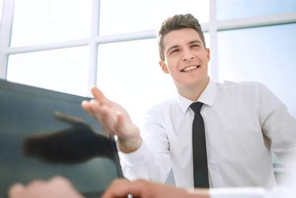 close up.a smiling employee pointing at the laptop screen