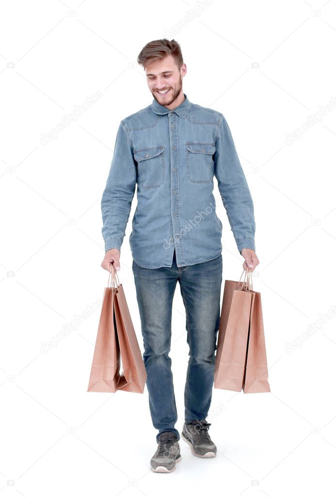 a young guy with brown paper bags in his hands.
