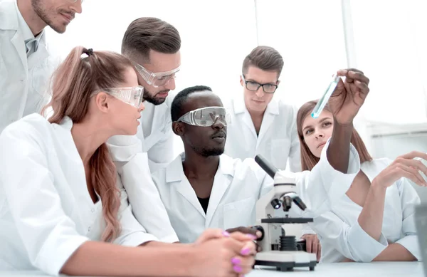 Grupo de jovens clínicos experimentação em laboratório de pesquisa — Fotografia de Stock