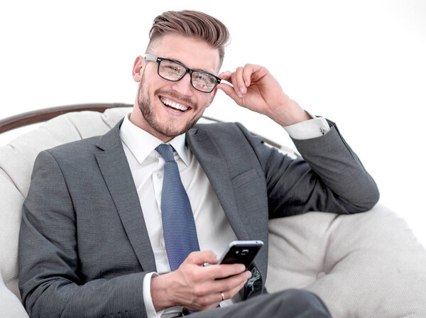 close up.a successful businessman looks at a text on his smartphone