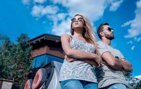 Bottom view.beautiful couple standing near a convertible car — Stock Photo, Image
