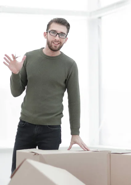 Чоловік дивиться на коробки в новому будинку — стокове фото
