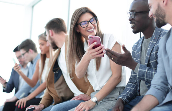 group of young people with smartphones