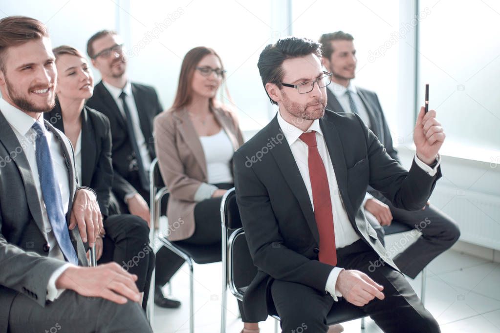 Manager asks a question at a business meeting