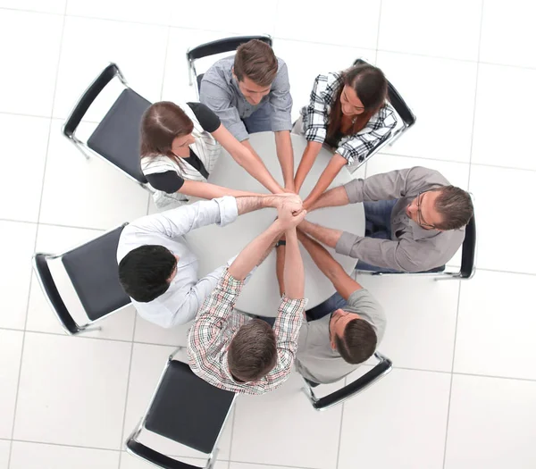 Top view.the smiling business team folded their hands together — Stock Photo, Image