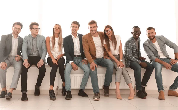 young people are waiting for an interview, sitting in the office lobby