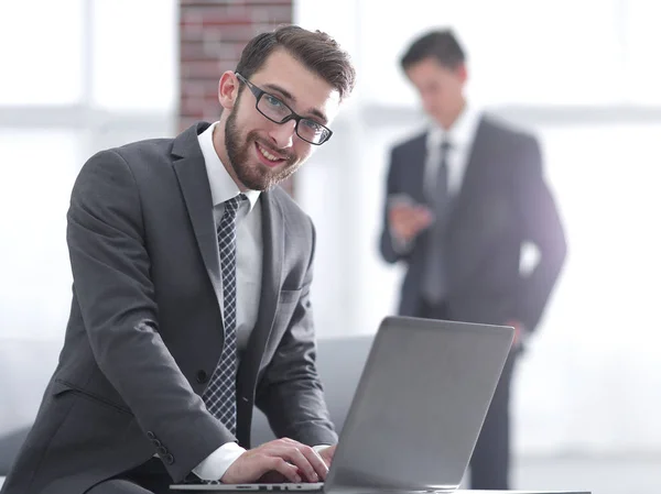 Handsome businessman is working with laptop in office — Stock Photo, Image