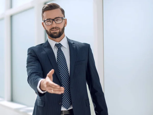 Successful businessman holding out his hand for a handshake — Stock Photo, Image