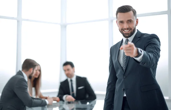 Smiling businessman standing in the office and pointing at you — Stock Photo, Image