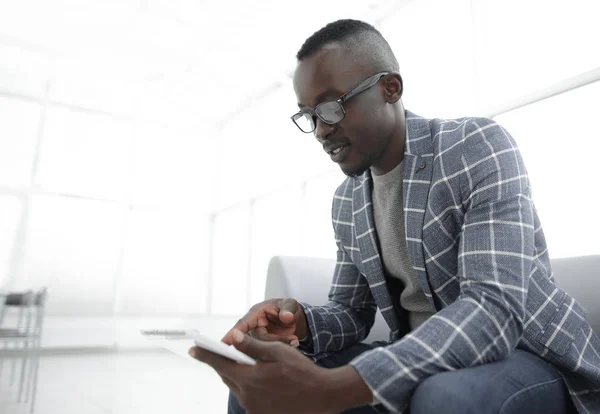 Zakenman met behulp van digitale tablet zitten in de wachtkamer van office — Stockfoto